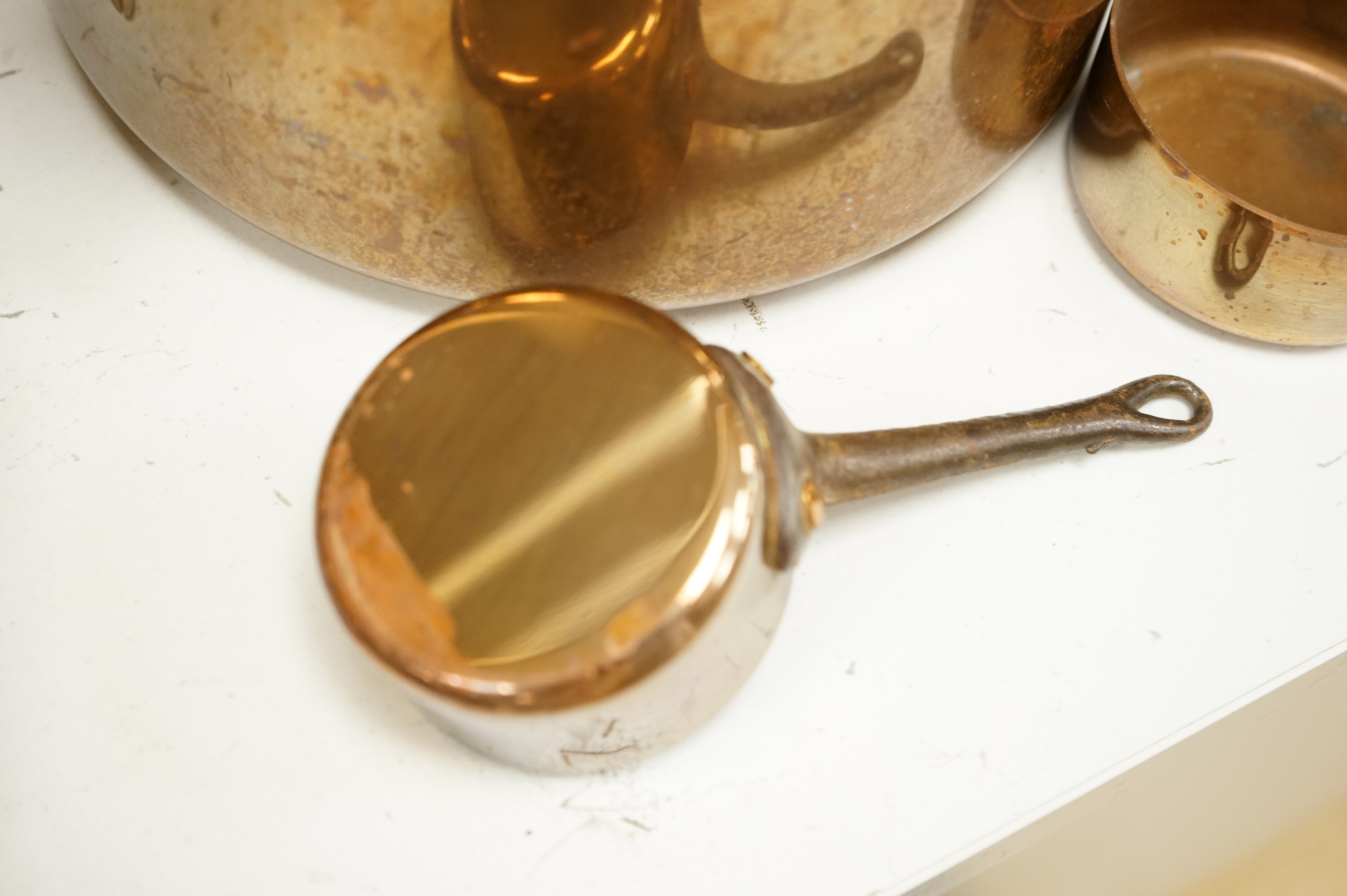 A graduated set of copper saucepans, largest 20.5cm diameter, smallest 6.5cm